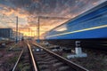 High speed passenger train in motion on railroad track at sunset Royalty Free Stock Photo