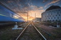 High speed passenger train in motion on railroad track at sunset Royalty Free Stock Photo