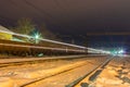 High speed passenger train on railroad tracks with motion blur effect near the railway station Royalty Free Stock Photo