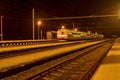 High speed passenger train on tracks with motion blur effect at night. Railway station in the Czech Republic Royalty Free Stock Photo