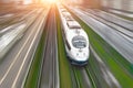 High-speed passenger train travels at high speed railroad green grass. Top view with motion effect, greased background.