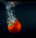 High speed photography tomato splash in water over black