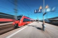 High speed red train in motion on the railway station Royalty Free Stock Photo