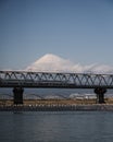 High-speed Shinkansen train over Fuji river with a mesmerizing Fuji mountain on the background