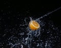 A high-speed shot of a lemon with splashing water, on a black background. Royalty Free Stock Photo