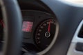 High speed on tachometer on black dashboard in automobile