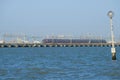 High-speed train `FrecciarGento` Silver Arrow of the Trenitalia train company arrives on a dam to Venice