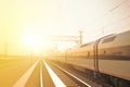 high speed train leaves train station at sunset, modern train enjoy smooth journey on the rail line