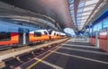 High speed train on the modern railway station at sunset Royalty Free Stock Photo