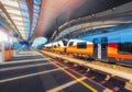 High speed train on the modern railway station at sunset