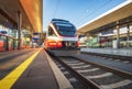 High speed train on the modern railway station at sunset Royalty Free Stock Photo