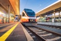 High speed train on the modern railway station at sunset Royalty Free Stock Photo