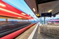 High speed train in motion on the railway station at dusk Royalty Free Stock Photo