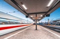High speed train in motion on the railway station at night Royalty Free Stock Photo