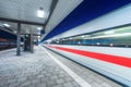 High speed train in motion on the railway station at night Royalty Free Stock Photo