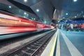 High speed train in motion on the railway station at night