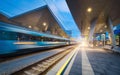 High speed train in motion on the railway station at night