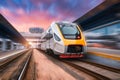 High speed train in motion on the railway station at sunset Royalty Free Stock Photo