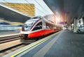 High speed train in motion on the railway station at sunset Royalty Free Stock Photo