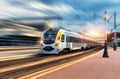 High speed train in motion at the railway station at sunset Royalty Free Stock Photo