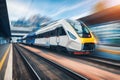 High speed train in motion on the railway station at sunset Royalty Free Stock Photo