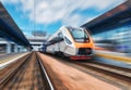 High speed train in motion on the railway station at sunset Royalty Free Stock Photo