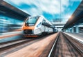 High speed train in motion on the railway station at sunset Royalty Free Stock Photo