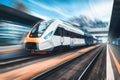 High speed train in motion on the railway station at sunset Royalty Free Stock Photo