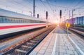 High speed train in motion on the railway station at sunset Royalty Free Stock Photo