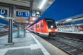 High speed train on the railway station at night Royalty Free Stock Photo