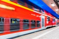 High speed train at railway station platform at night