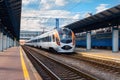 High speed train at the railway station at sunset