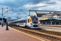 High speed train at the railway station at sunset