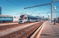 High speed train at the railway station at sunset