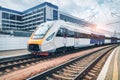 High speed train on the railway station at sunset Royalty Free Stock Photo