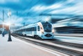 High speed train at the railway station at sunset Royalty Free Stock Photo