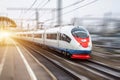 High speed train rides at high speed at the railway station in the city. Royalty Free Stock Photo