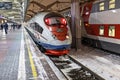 A high-speed train stands on the platform of the station waiting for departure. Winter Royalty Free Stock Photo