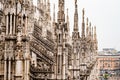 High spires with sculptures on top in the Duomo. Milan, Italy