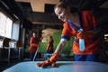 Three female workers using various janitorial supplies during the clean-up Royalty Free Stock Photo