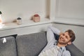 Cheerful male entrepreneur reposing in his office