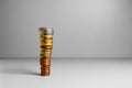 High stack of coins with free space for text on gray background. Coins are arranged from smaller to larger Royalty Free Stock Photo