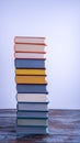 A high stack of used books in fabric bright multi-colored covers with textured paper cuts. Royalty Free Stock Photo