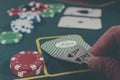 High stakes poker pair of aces and tower of chips on green baize table in strategic display Royalty Free Stock Photo