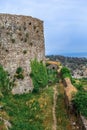 The high stone wall of the ancient Rozafa Castle and the walking path Royalty Free Stock Photo