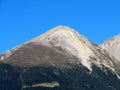 High swiss alpine peak Piz Linard (2767 m) above the tourist-agricultural village Alvaneu Bad (Alvagni Bogn) Royalty Free Stock Photo