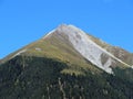 High swiss alpine peak Piz Mulain (2627 m) above the tourist-agricultural village Alvaneu Bad (Alvagni Bogn)