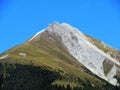High swiss alpine peak Piz Mulain (2627 m) above the tourist-agricultural village Alvaneu Bad (Alvagni Bogn)
