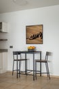 High table with chairs and fruit bowl in dining area