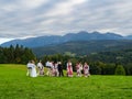 High Tatra mountains in Poland. View from Lapszanka near Zakopan. People in traditional outfit having wedding photoshoot in